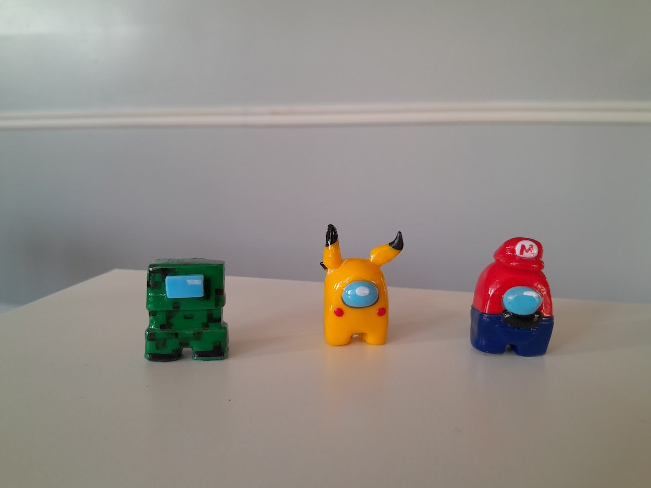 Finished clay figurines inspired by among us, minecraft, pokemon, pikachu and super mario, created by students in Goldfish Art’s clay sculpting and character modeling course for ages 5-18