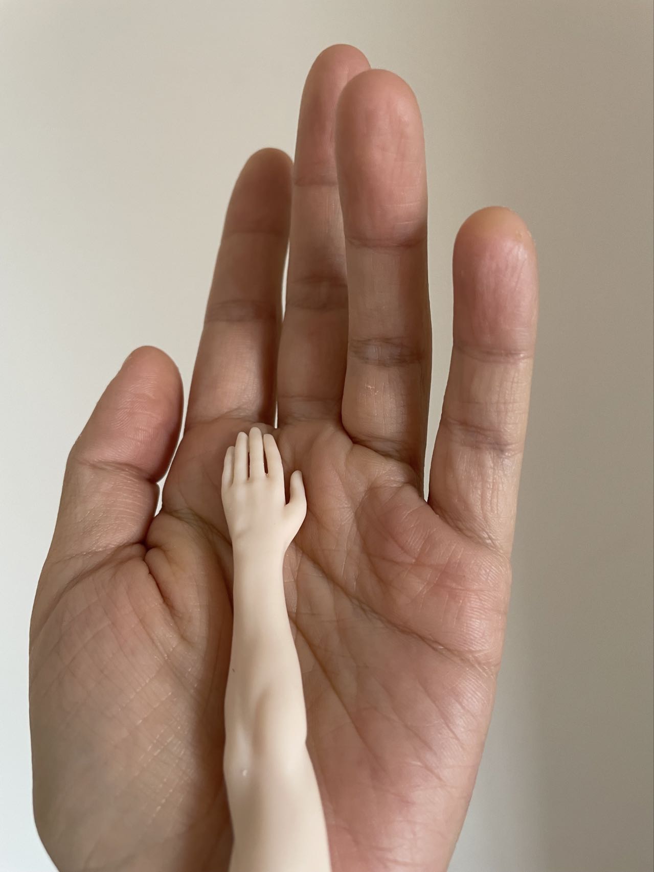 Close-up of hands shaping a clay figure, focusing on detailed character modeling and sculpting, created by teacher goldfish yao in Goldfish Art’s clay sculpting and character modeling course for ages 5-18