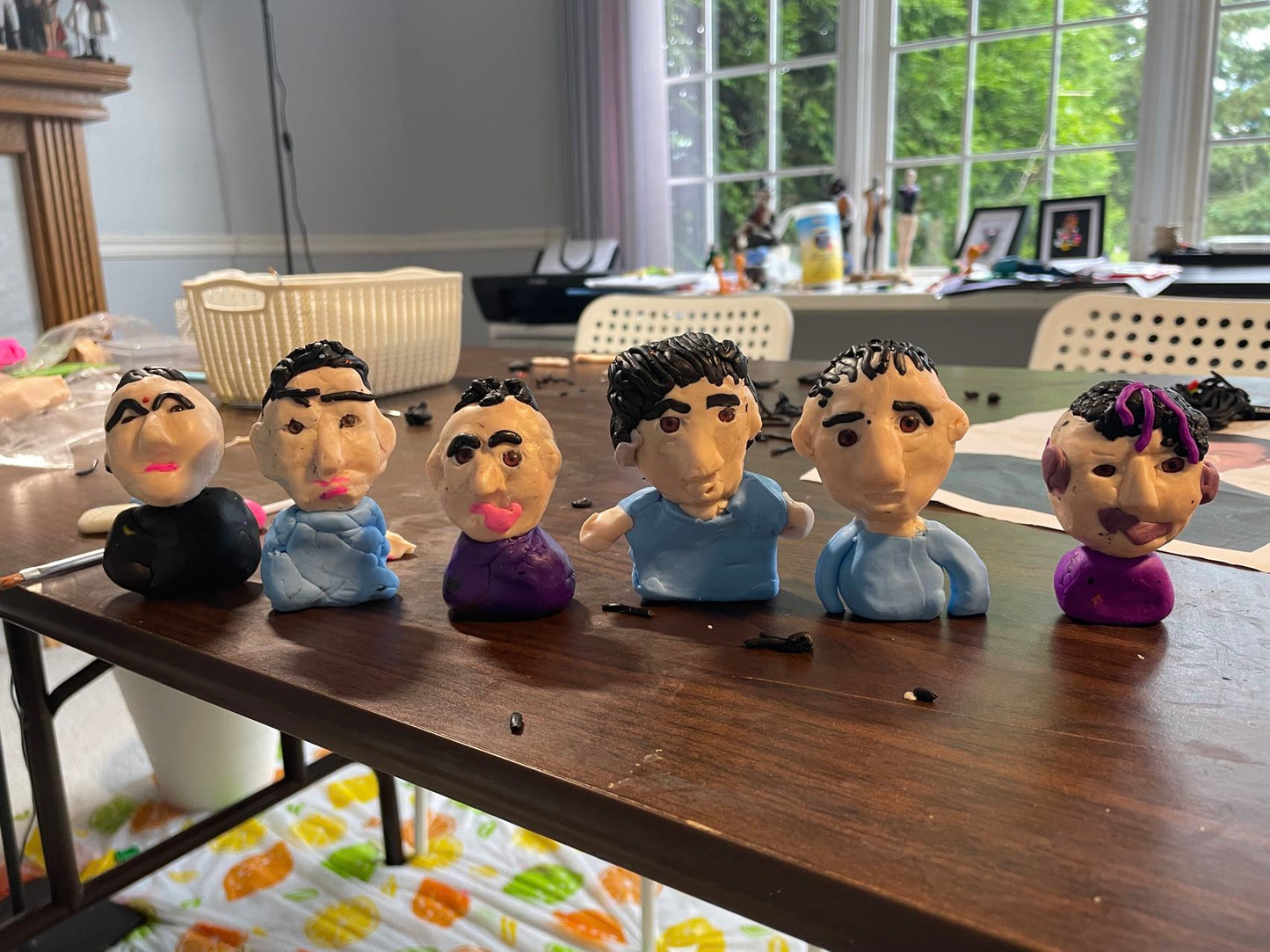Custom fathers day figurine, hand-sculpted and painted, displayed on a white background. Finished clay figurines created by students in Goldfish Art’s clay sculpting and character modeling course for ages 5-18