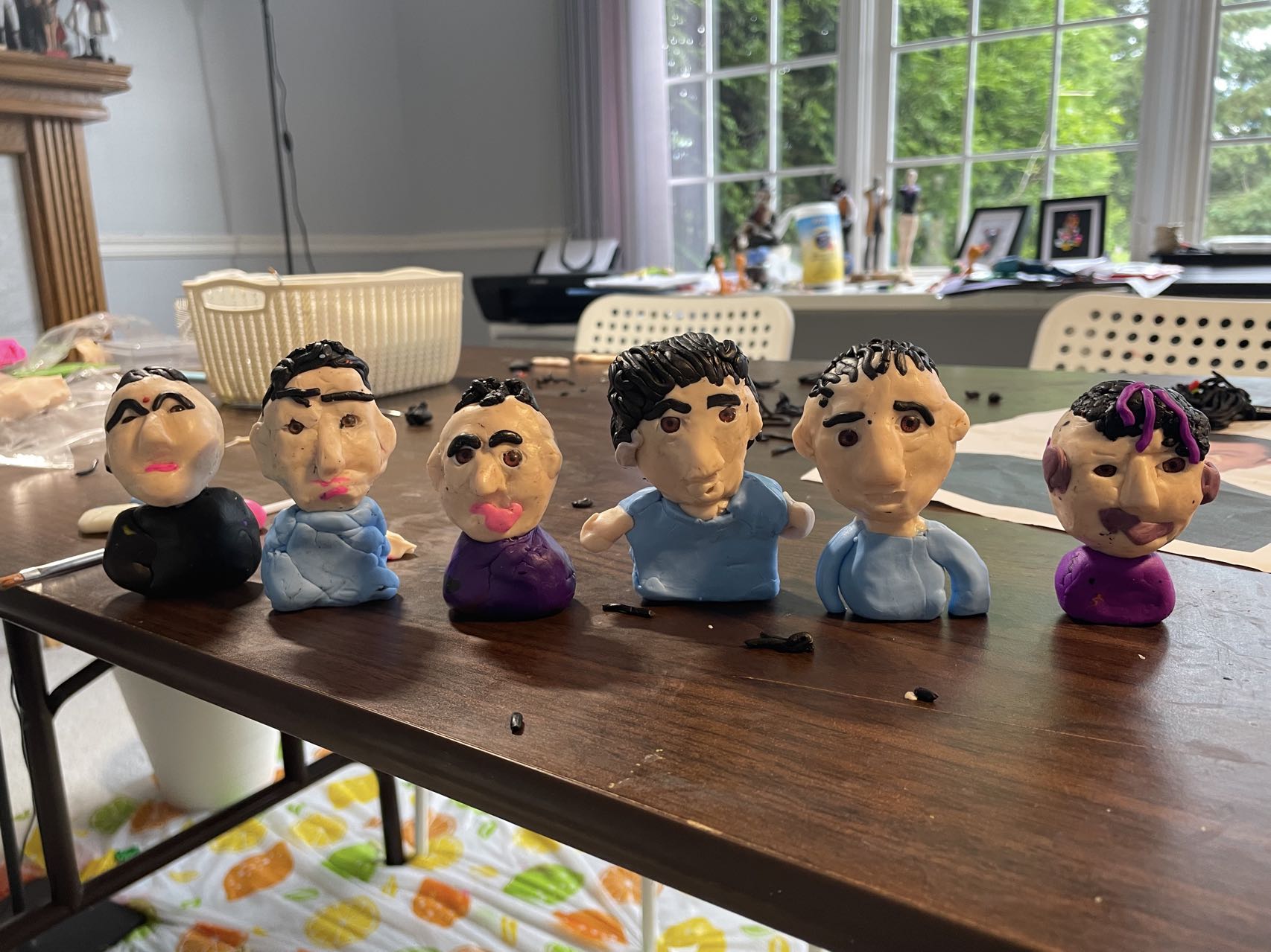 Custom fathers day figurine, hand-sculpted and painted, displayed on a white background. Finished clay figurines created by students in Goldfish Art’s clay sculpting and character modeling course for ages 5-18