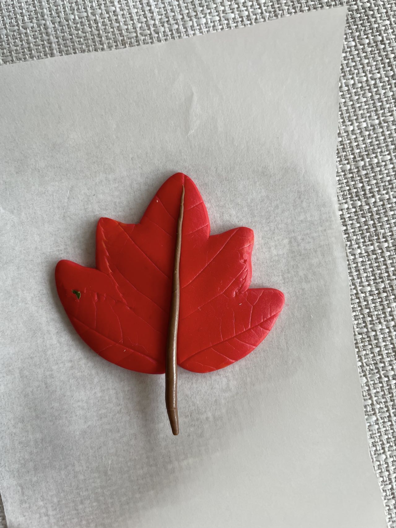 Custom maple leaf figurine, hand-sculpted and painted, displayed on a white background. Finished clay figurines created by students in Goldfish Art’s clay sculpting and character modeling course for ages 5-18