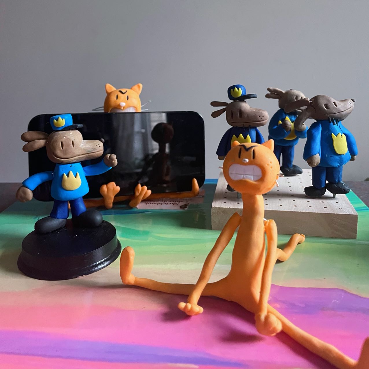 Finished clay figurines inspired by dogman and cat kid, created by students in Goldfish Art’s clay sculpting and character modeling course for ages 5-18