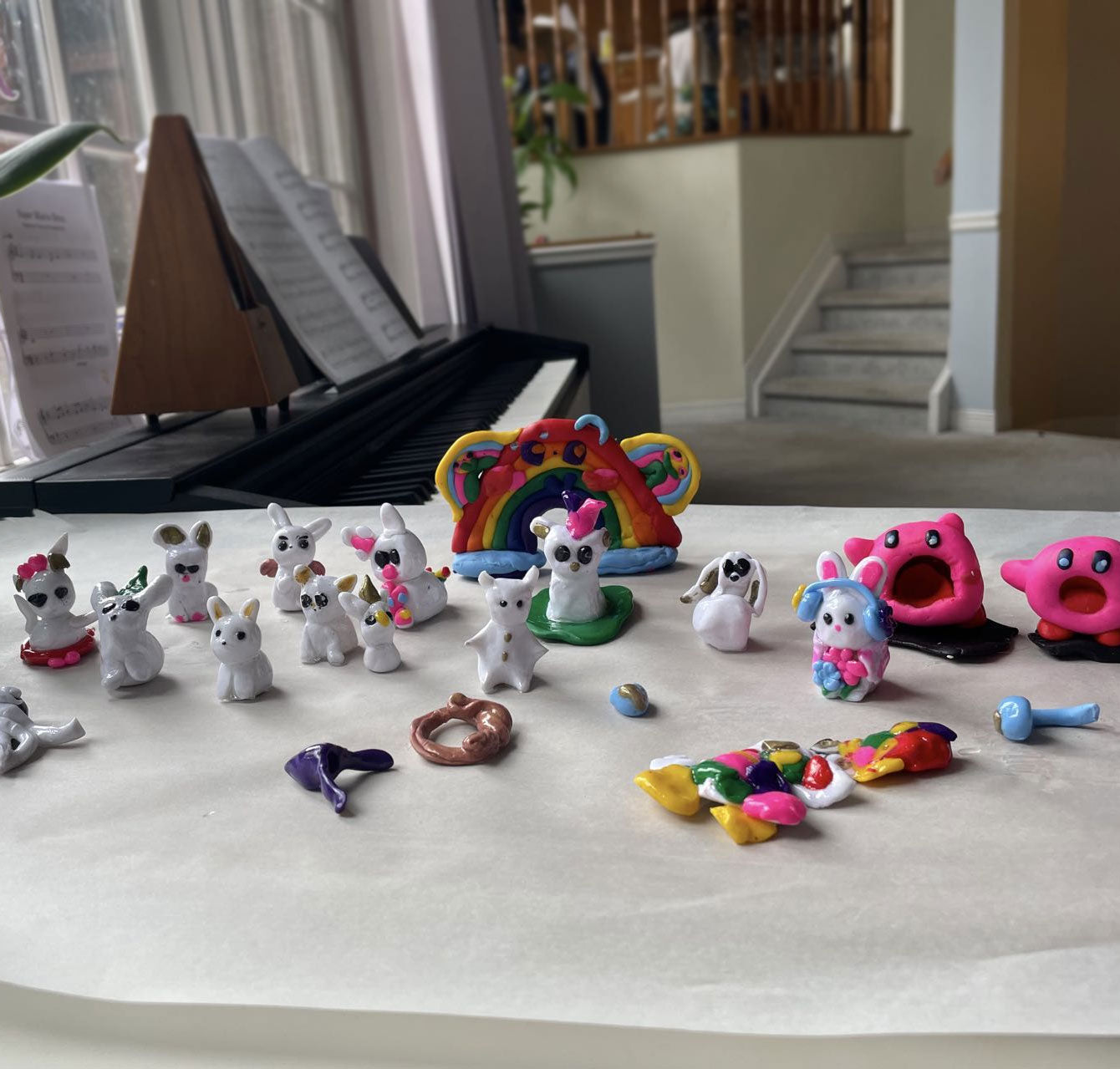 Custom easter bunny, rainbow, and kirby figurine, hand-sculpted and painted. Finished clay figurines created by students in Goldfish Art’s clay sculpting and character modeling course for ages 5-18