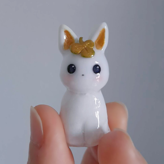 Custom easter bunny figurine, hand-sculpted and painted, displayed on a white background. Finished clay figurines created by teacher in Goldfish Art’s clay sculpting and character modeling course for ages 5-18